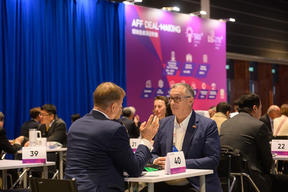 Two attendees in a one-to-one meeting at the AFF Deal-Making area